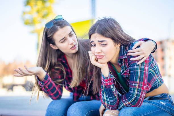 istock Young woman comforts a sad female friend 1215108991