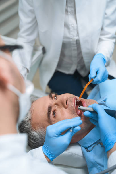 istock Man being treated at dentist stock photo 1215110601