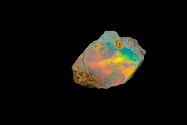 macro mineral stone rare and beautiful opals on a black background close-up