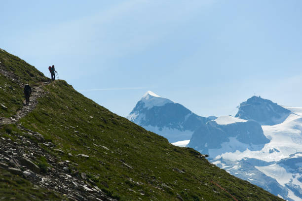 istock Tourists following path in mountains. 1215113116
