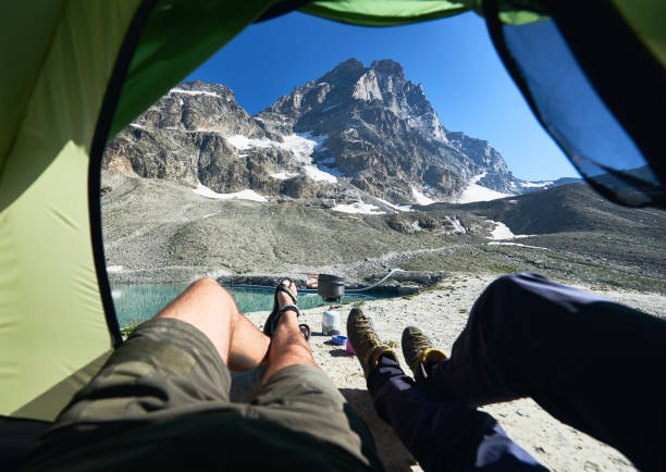istock Hikers looking at Matterhorn or Monte Cervino mountain from tent. 1215113374