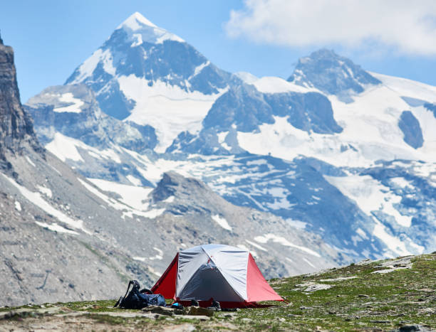istock Red and white camp tent in mountains. 1215113404