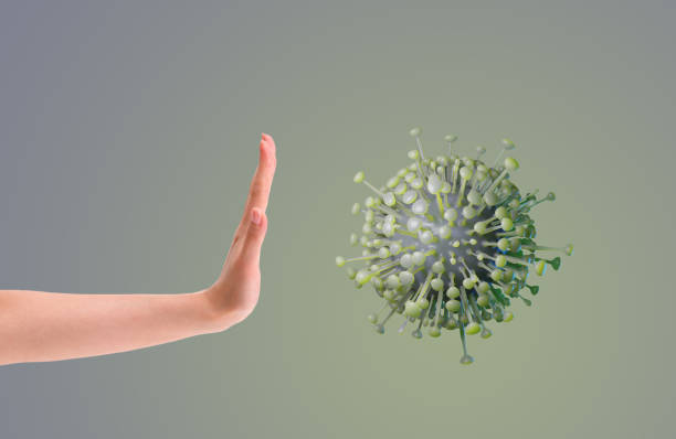 istock Hand making gesture rejection CORONA virus cells symbols or covid-19. 1215113723