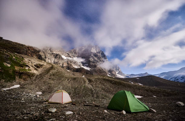 istock Matterhorn, Monte Cervino mountain with camp tents at night. 1215115030