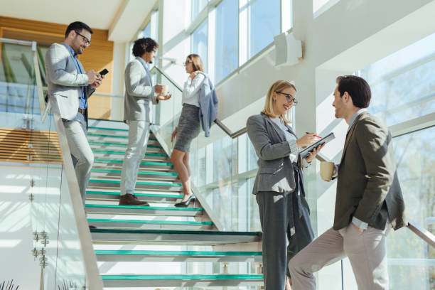 istock Two business people discussing report on stairs 1215115311
