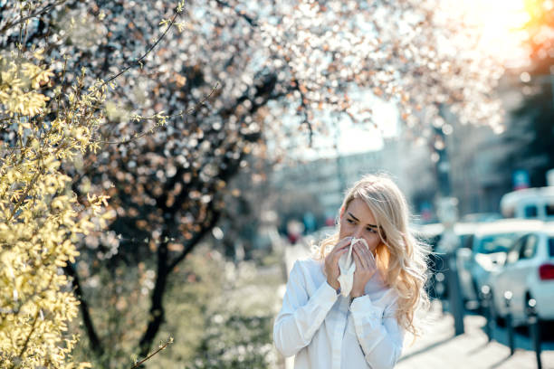 donna starnutisce nel giardino in fiore - allergy pollen tree hay fever foto e immagini stock