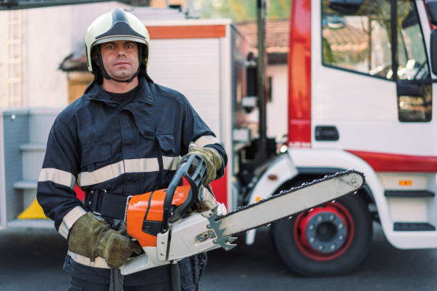 Portrait of mid adult firefighter preparing his equipment