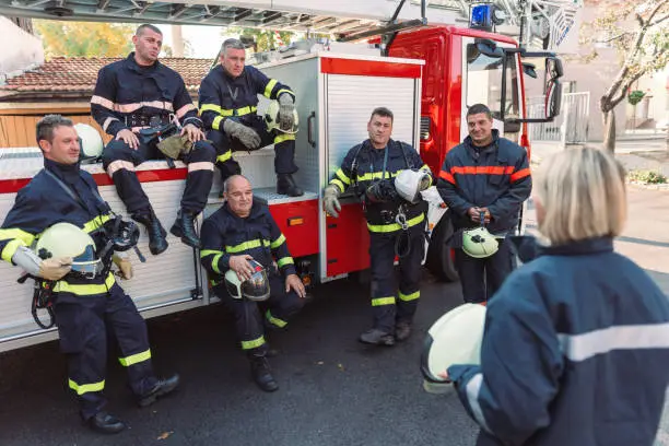 Photo of Chief female firefighter conducting routine briefing