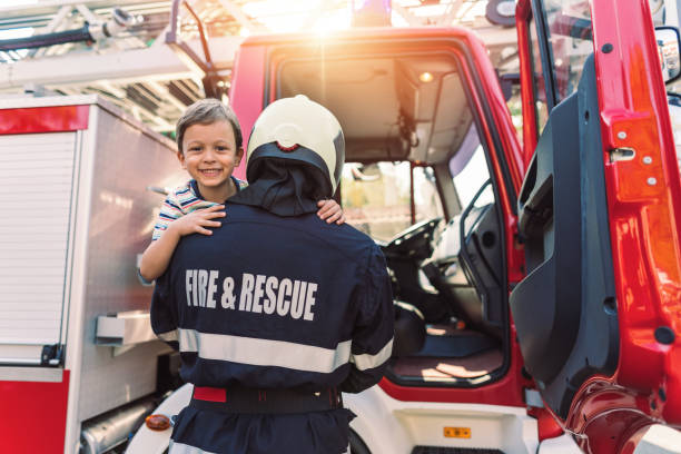 istock Little boy meeting real firefighter 1215115668