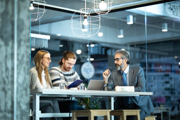 istock Young couple making plans with their agent in the office. 1215116789
