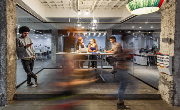 istock Young creative people working in the office among people in blurred motion. 1215117564