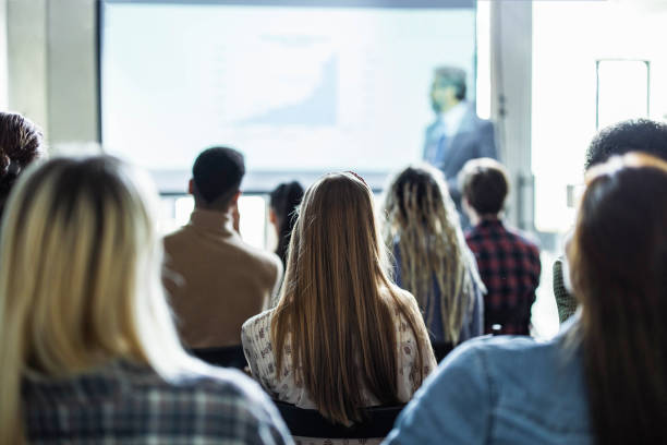 istock Back view of creative people on education event in the office. 1215117685