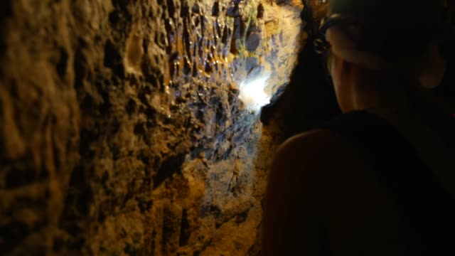 People exploring an ancient cave