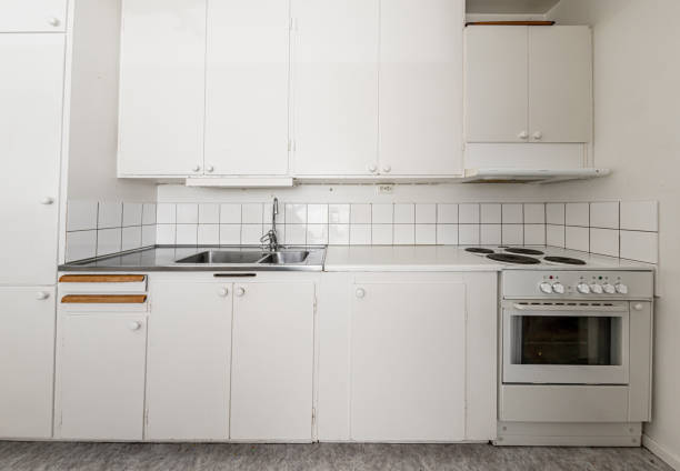istock Old, white kitchen with a sink and stove. 1215120769