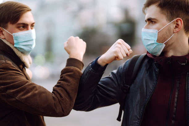 istock Elbow bump is new greeting to avoid the spread of coronavirus. 1215121444