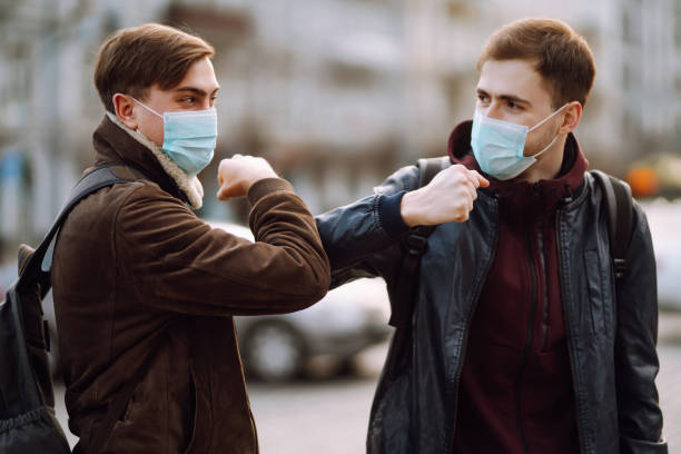 istock Elbow bump is new greeting to avoid the spread of coronavirus. 1215121530