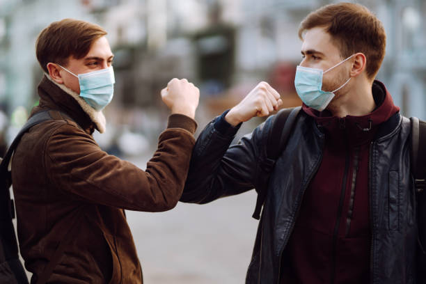 istock Elbow bump is new greeting to avoid the spread of coronavirus. 1215121531