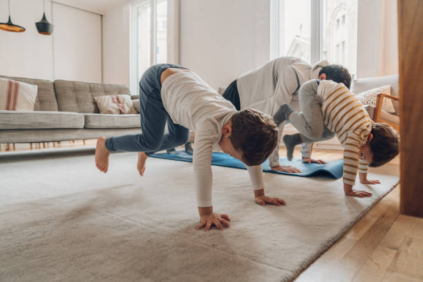 istock Father with children exercising at home 1215123227