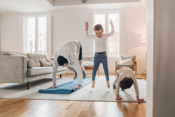 istock Father with children exercising at home 1215123266