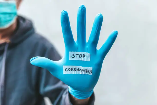 Photo of The glove-wearer has a message to stop the Coronavirus