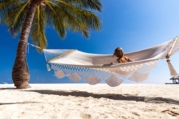 istock Carefree kid swinging in hammock on the beach. 1215125145