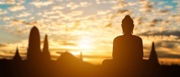 silhouette of buddha on golden temple sunset background. travel attraction in thailand. - buddhist puja imagens e fotografias de stock