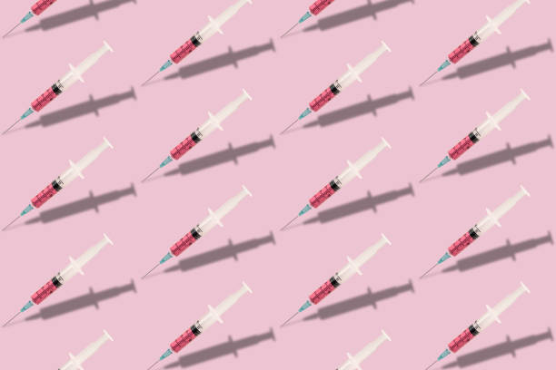 istock Beautiful creative pattern syringe medical on a pink background. Coronavirus concept, Protect yourself. 1215126084