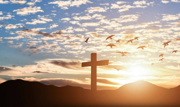 istock Silhouette of catholic cross at sunset background. 1215126099