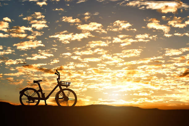 istock Silhouette of a bicycle against sunset background. 1215126255