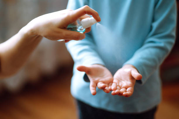 istock Mother and child using sanitize antiseptic for hand coronavirus protection. 1215128887
