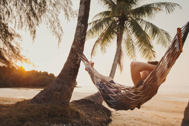 istock tourist relaxing in hammock on tropical beach 1215128964