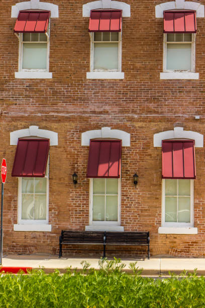 istock Six Windows And Awnings On Side Of Building 1215130870
