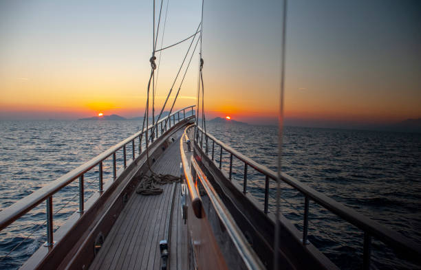 istock Beautiful dawn on the sea and yacht's bow 1215131524