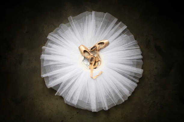 ballettschuhe mit bändern auf einem weißen tutu in einem tanzstudio - ballettröckchen stock-fotos und bilder