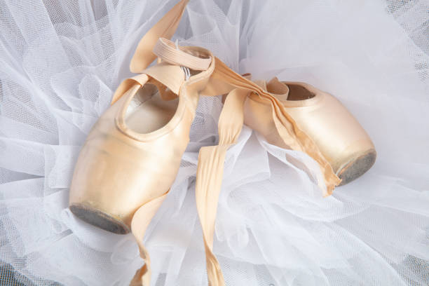 istock Ballet shoes with ribbons on a white tutu in a dance studio 1215132411