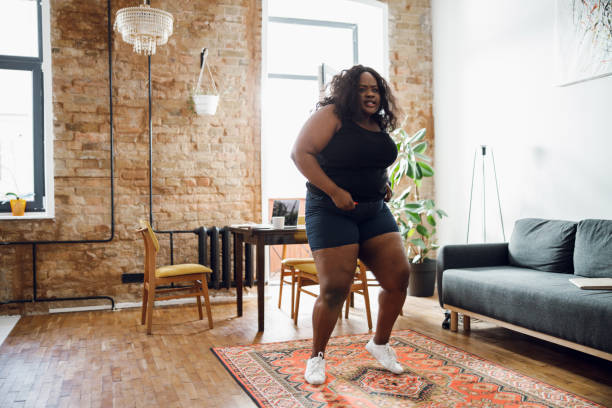 istock Plus size lady exercising with serious face stock photo 1215132773
