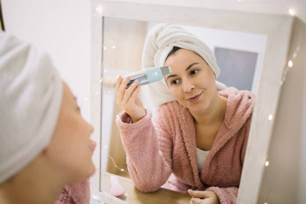 istock Girl doing deeply cleaning procedure with ultrasonic vibrations massager 1215133053