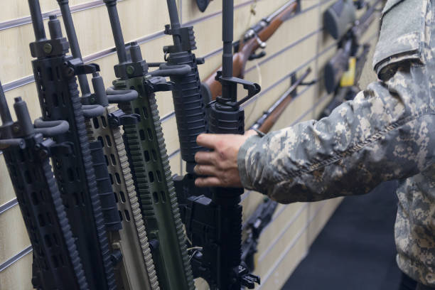 istock Man with an automatic rifle at the store. Weapons 1215135712