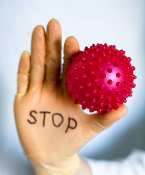 istock Stop Covid-19. Text on medical glove. 1215135740