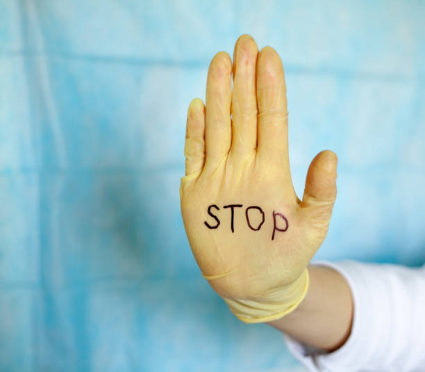 istock Stop. Text on a medical glove. 1215135741