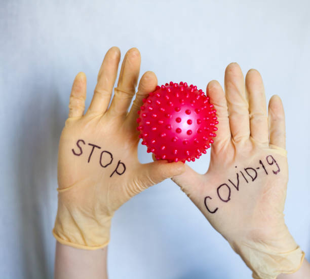 istock Stop Covid-19. Text on medical gloves. 1215135743
