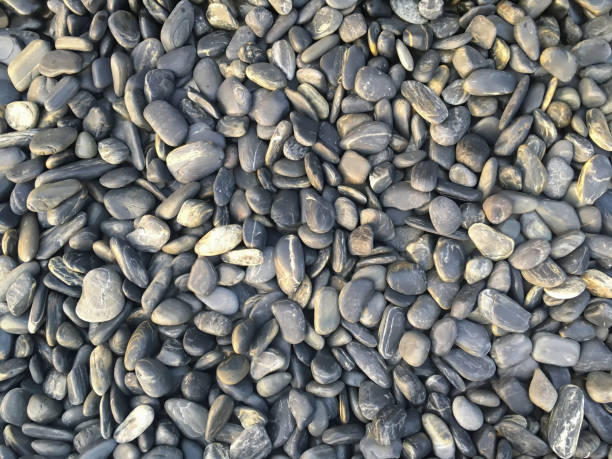 istock Closeup on white grey rocks and pebbles stone pattern and texture background. 1215135797
