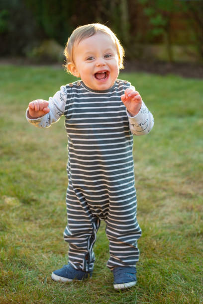 istock Baby boy 10 months old standing on grass 1215135801