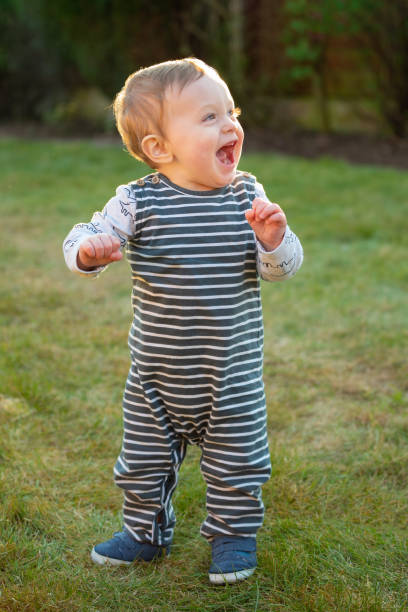 istock Baby boy 10 months old standing on grass 1215135831
