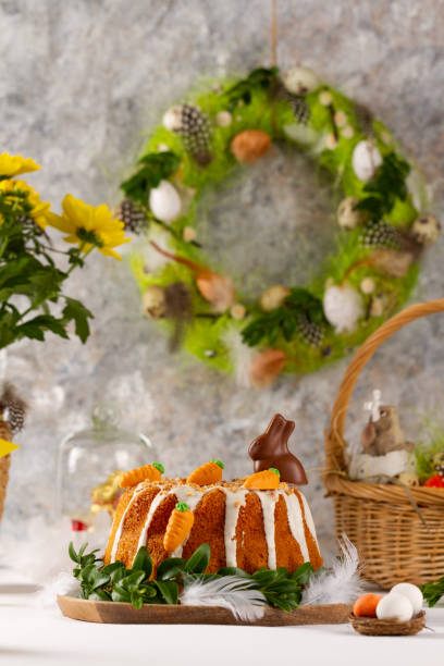 istock Easter lemon cake with icing and easter decoration. Easter gugelhupf cake with marzipan carrots and chocolate easter bunny 1215136966