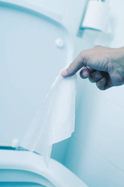 istock man throwing a wet wipe to the toilet 1215137009