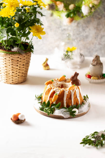 istock Easter lemon cake with icing and easter decoration. Easter gugelhupf cake with marzipan carrots and chocolate easter bunny 1215137068