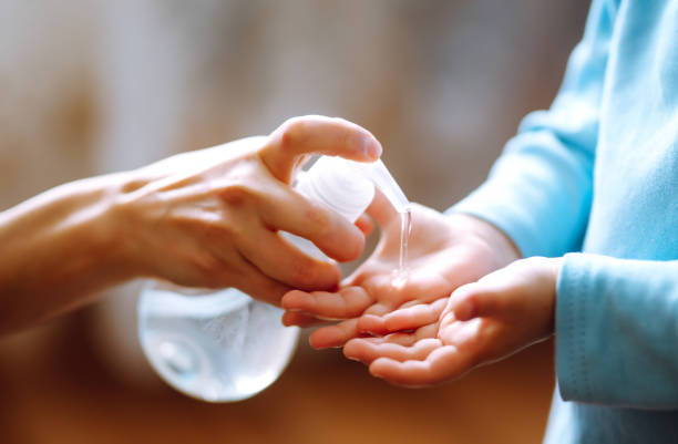 istock Mother and child using sanitize soap, gel for hand coronavirus protection. 1215137195
