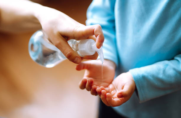 istock Mother and child using sanitize soap, gel for hand coronavirus protection. 1215137199