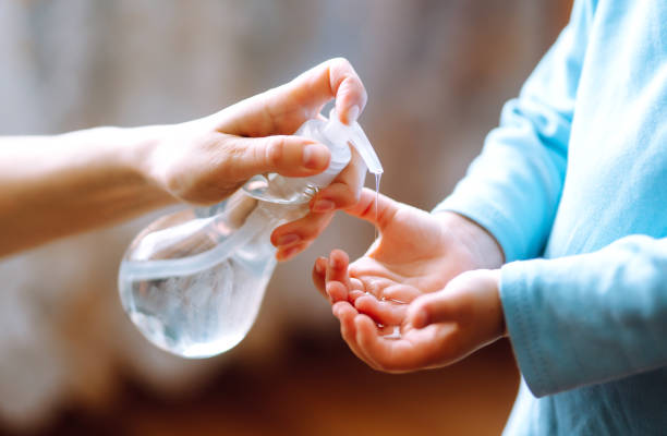 istock Mother and child using sanitize soap, gel for hand coronavirus protection. 1215137254